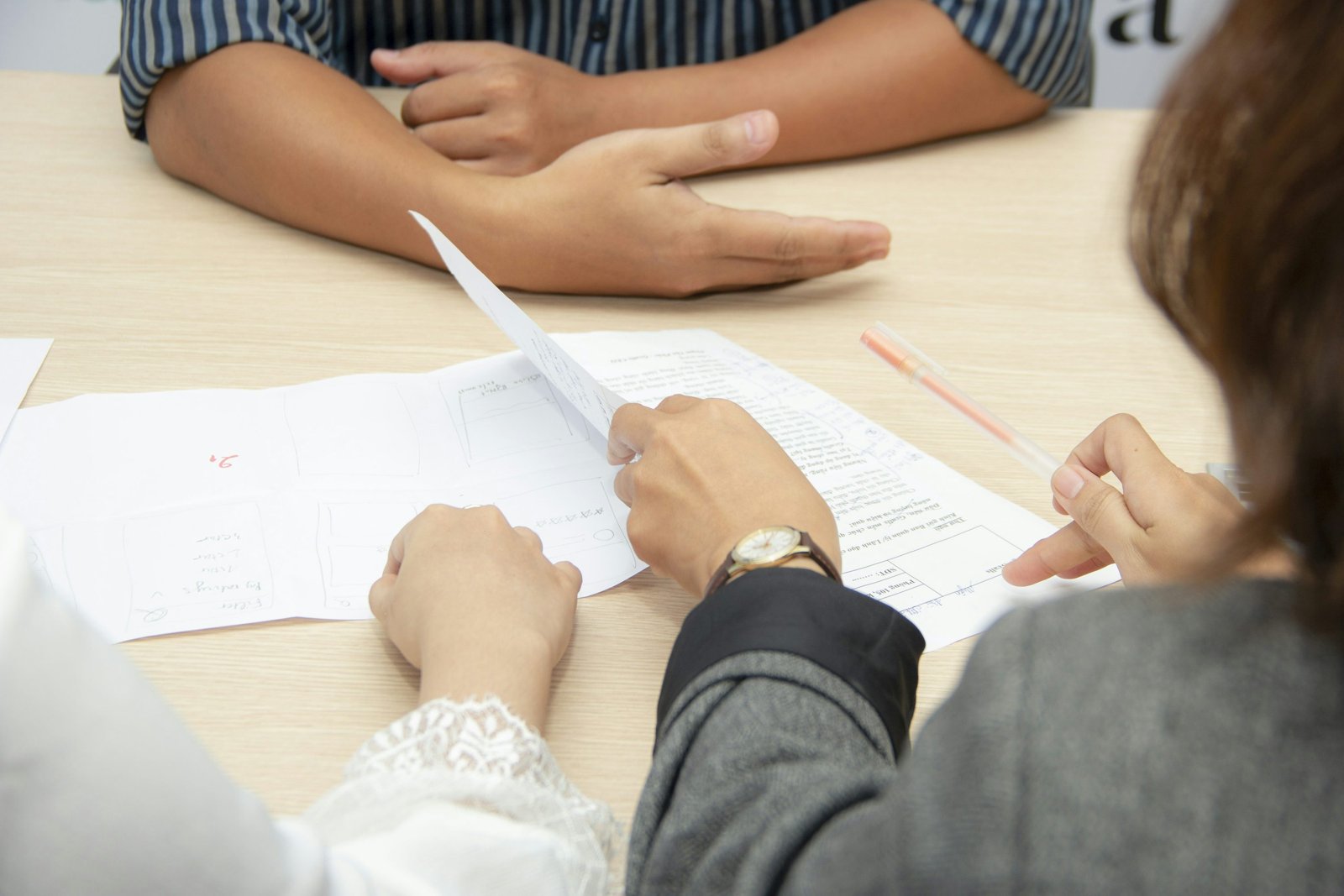 Person carefully checking documents at a desk